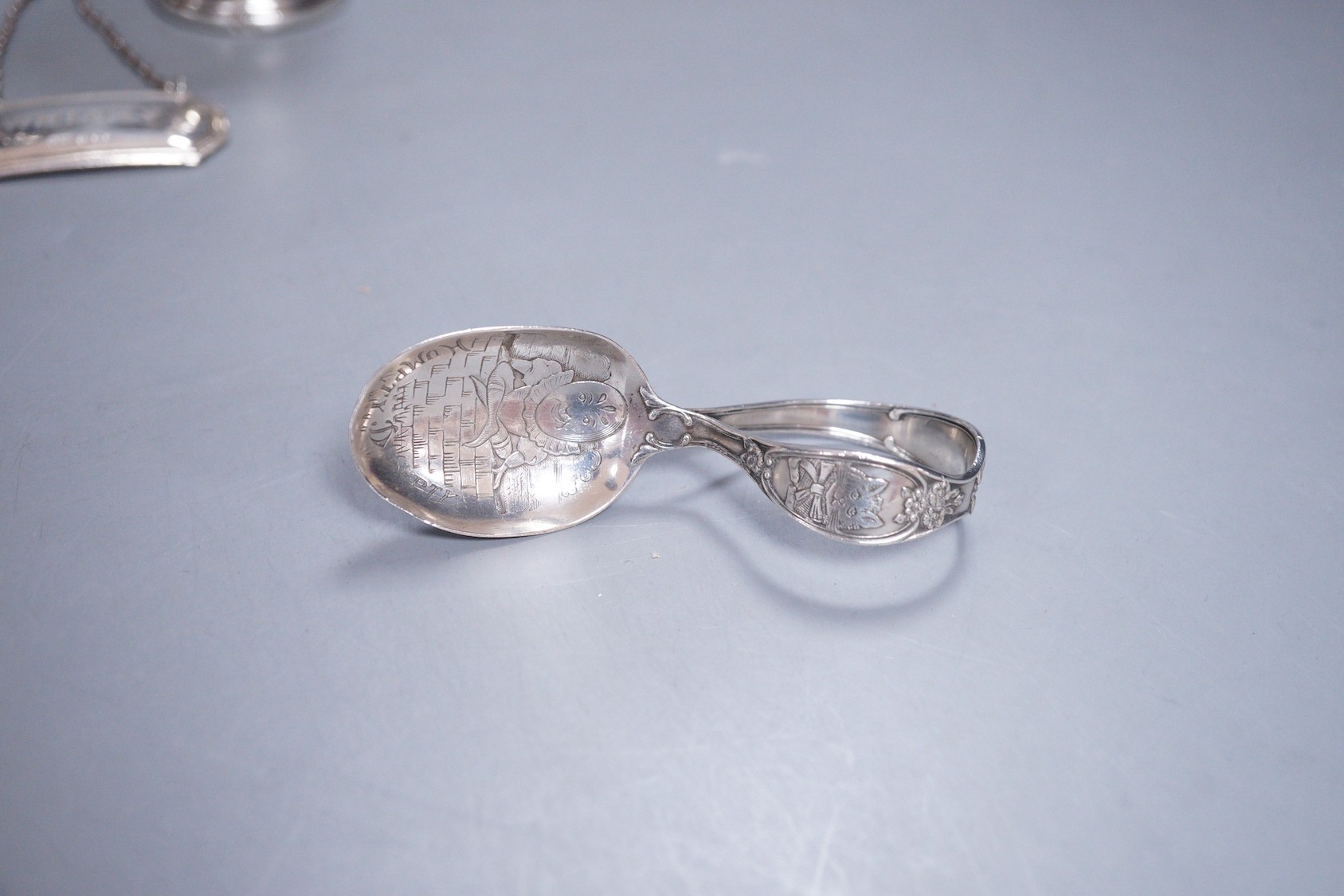 A group of small silver and white metal items including a sterling pedestal bowl. sterling 'Humpty Dumpty' child's spoon, a silver wine label, a sterling wine label, pierced silver lid and a sterling small vase